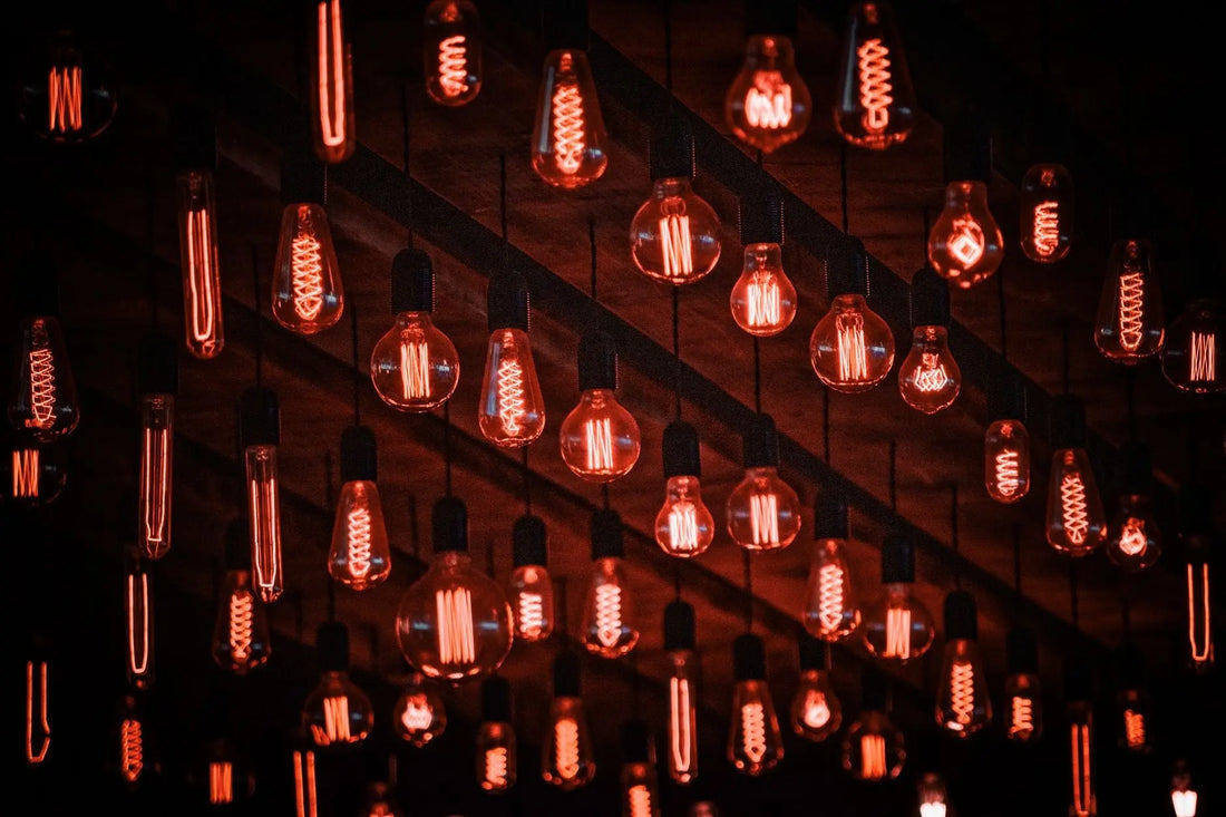 Multiple red-tinted vintage light bulbs hanging, creating a retro ambiance with a warm glow.