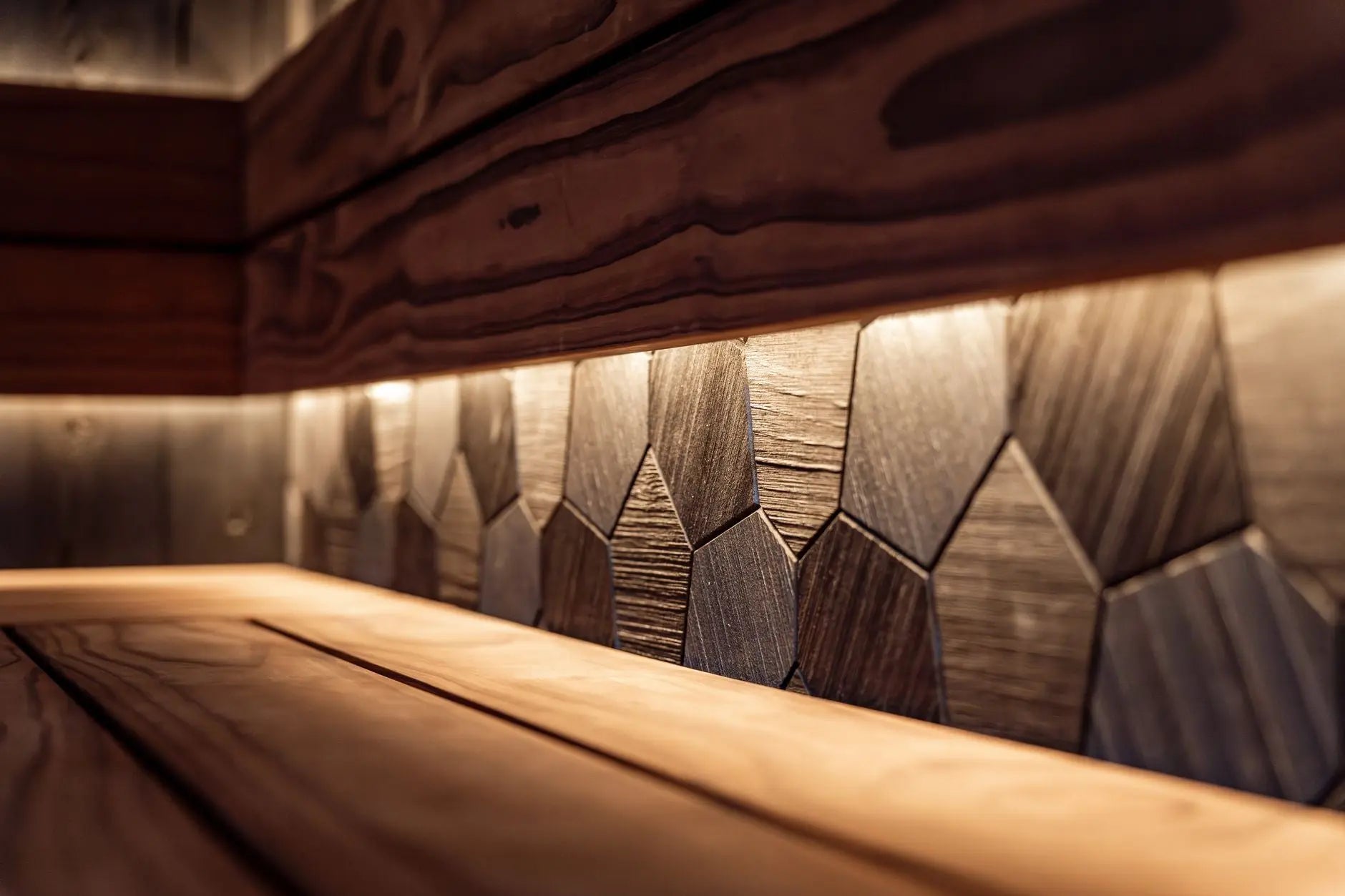 Interior of a modern sauna with LED lighting, featuring wooden benches and sleek wall panel design.