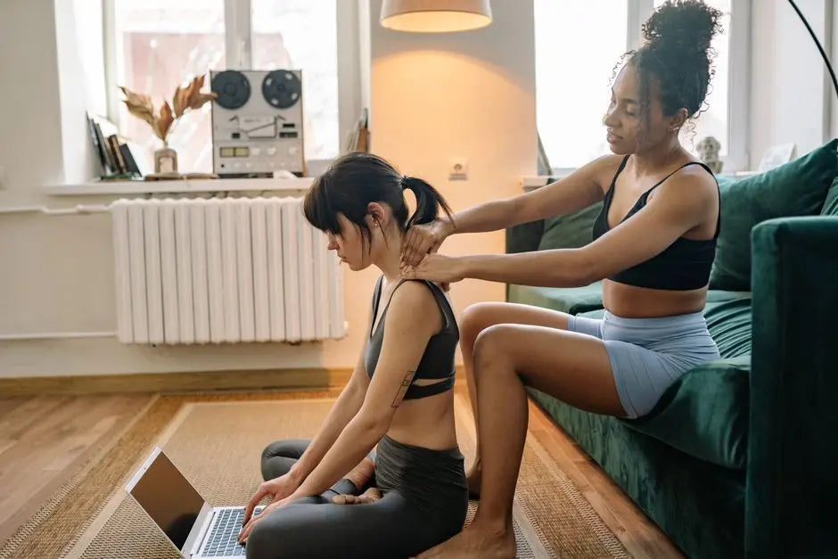 Two women in sportswear enjoying relaxation and comfort indoors, focusing on mental well-being.