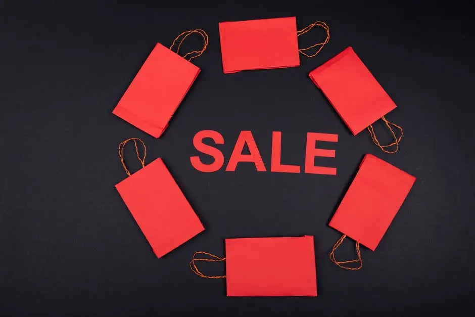 Circular arrangement of red paper bags with 'SALE' text on a dark background.