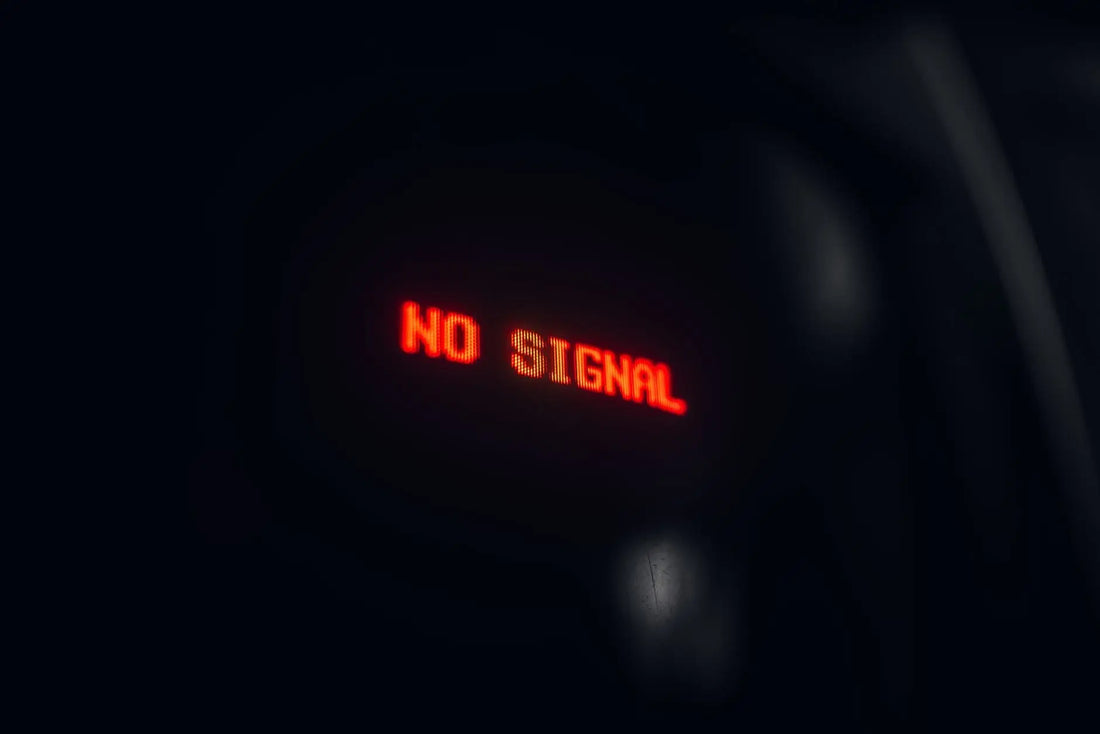A red LED display indicating 'No Signal' in a dark setting, conveying a tech warning.